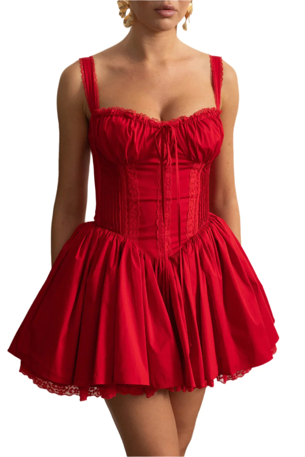 Red dress worn by a person against a decorative white wall.
