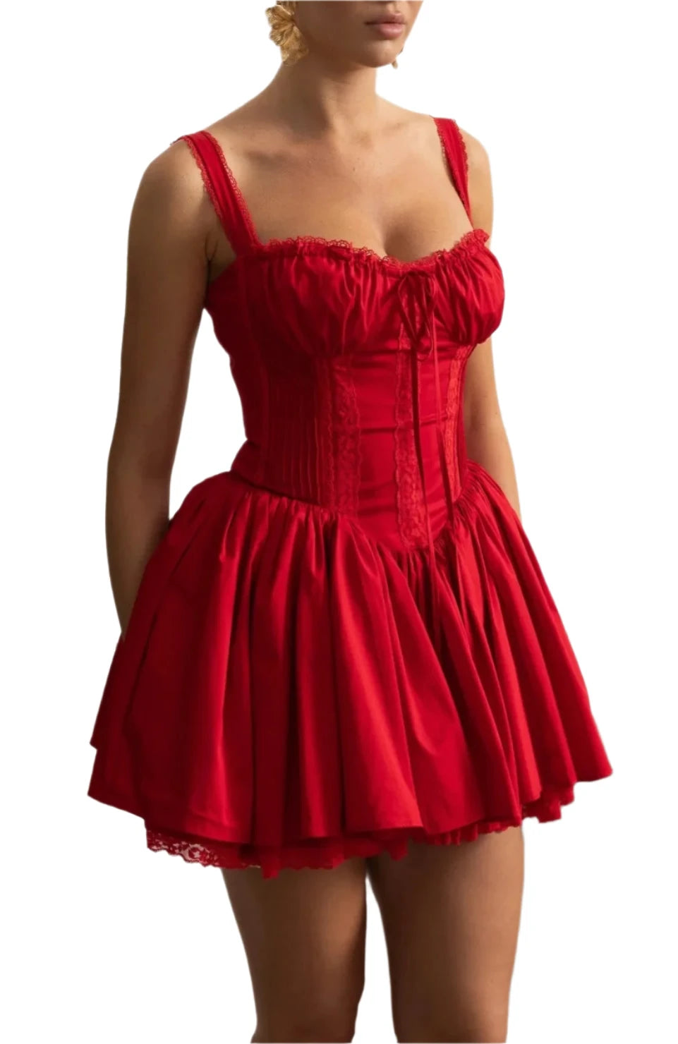 Woman wearing a red dress with a decorative wall and plant in the background