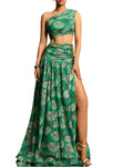 Woman wearing a green floral dress with a slit on a gradient background
