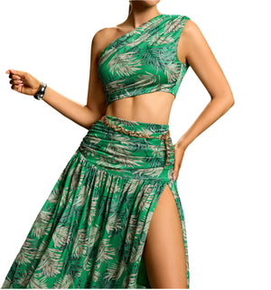 Woman wearing a green leaf-patterned dress against a gradient background