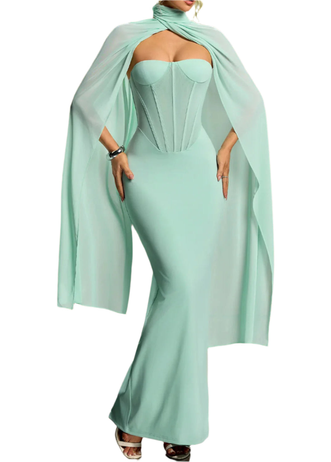 Mint green strapless dress with a flowing cape on a gradient background