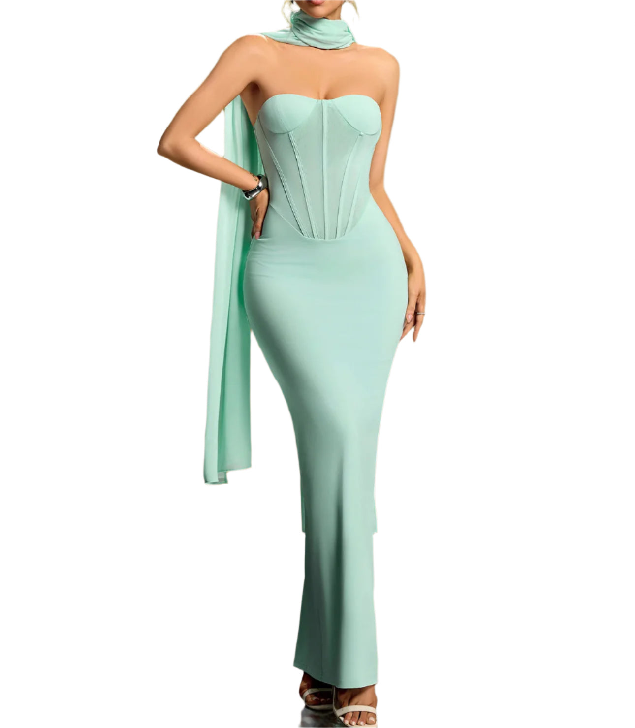 Mint green strapless gown with a draped fabric detail on a gradient background