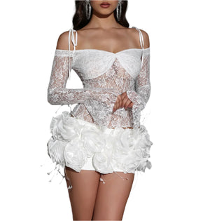 White lace dress with floral details on a gray background