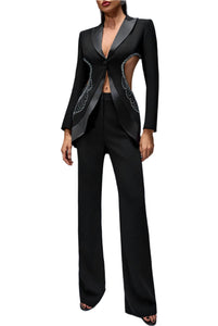 Black tuxedo-style outfit with intricate detailing on a gray background