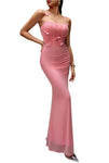 Woman wearing a pink evening gown against a gray background
