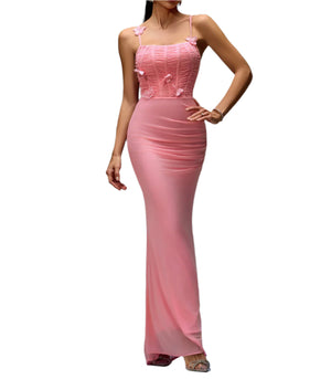 Woman wearing a pink evening gown against a gray background