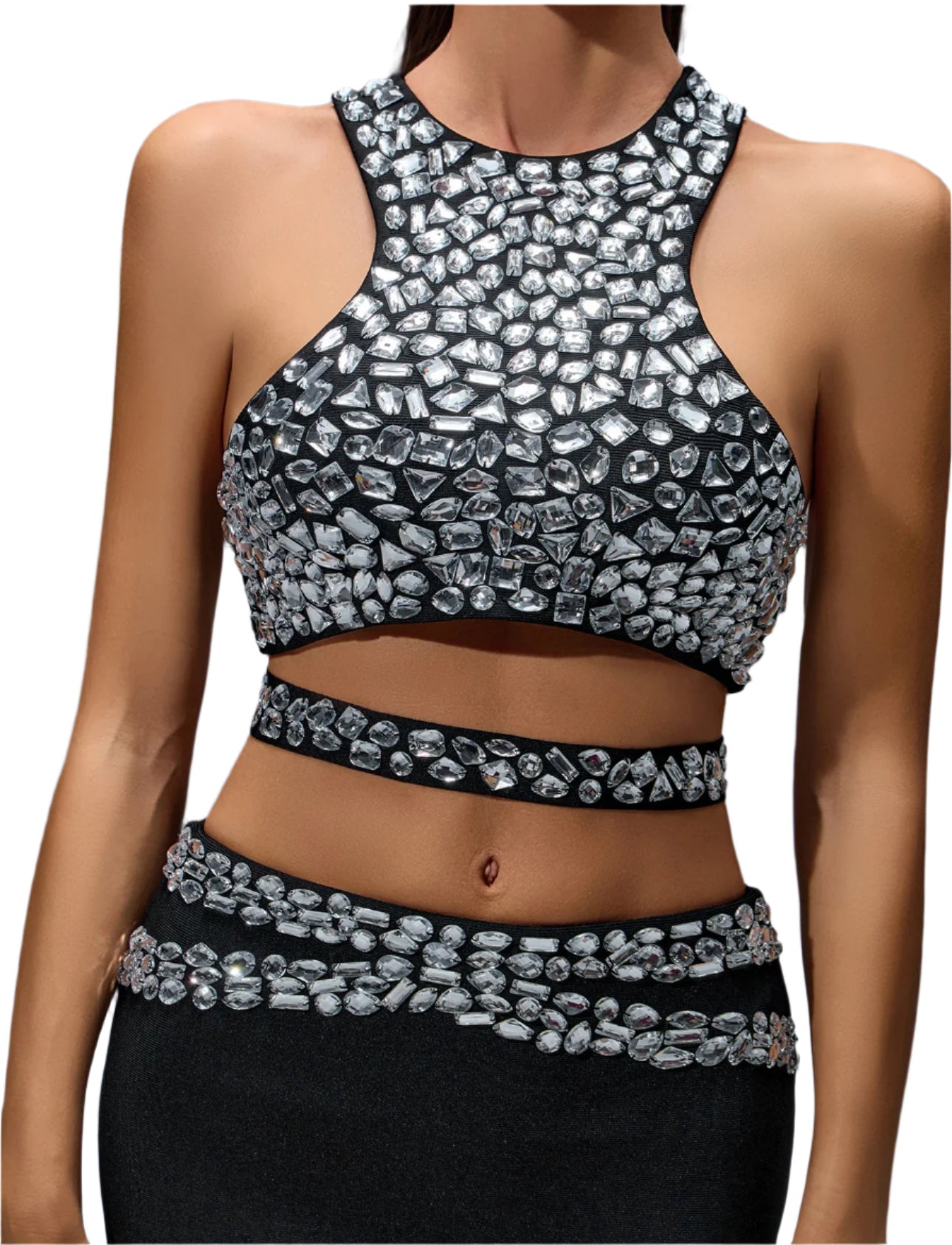 Silver beaded crop top and black pants on a model against a dark background