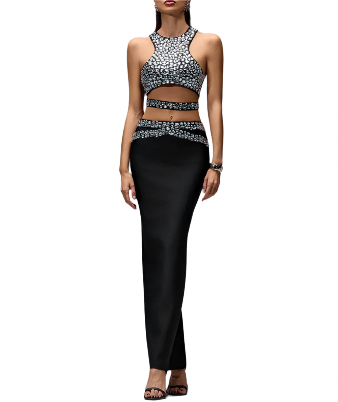 Woman wearing a patterned top and black pants on a gray background