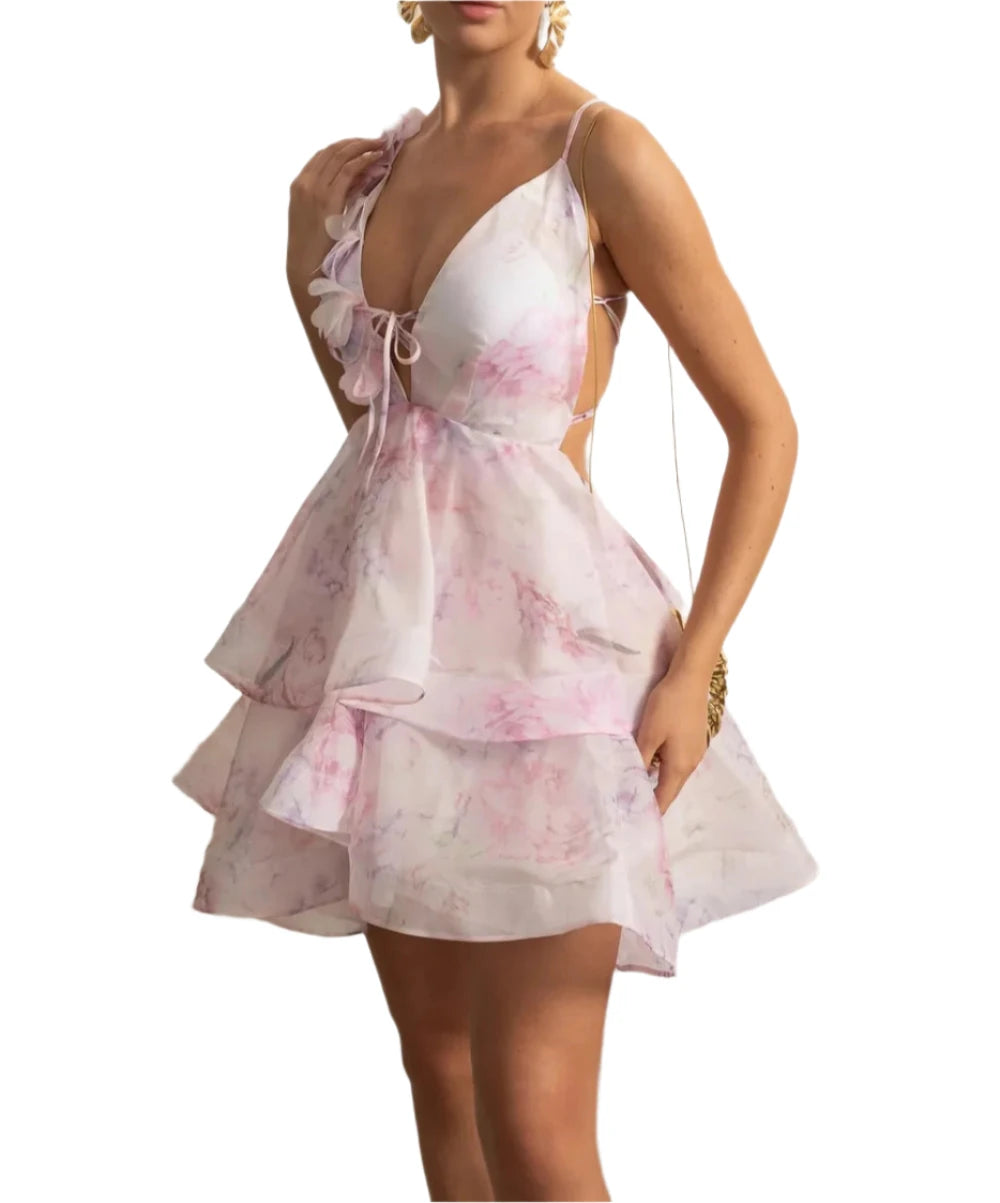 Woman wearing a pink floral dress in an elegant interior setting