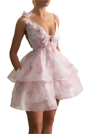 Woman wearing a pink floral dress in an elegant interior setting