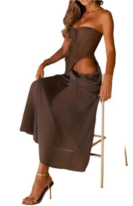Woman in a brown dress sitting on a chair in an indoor setting